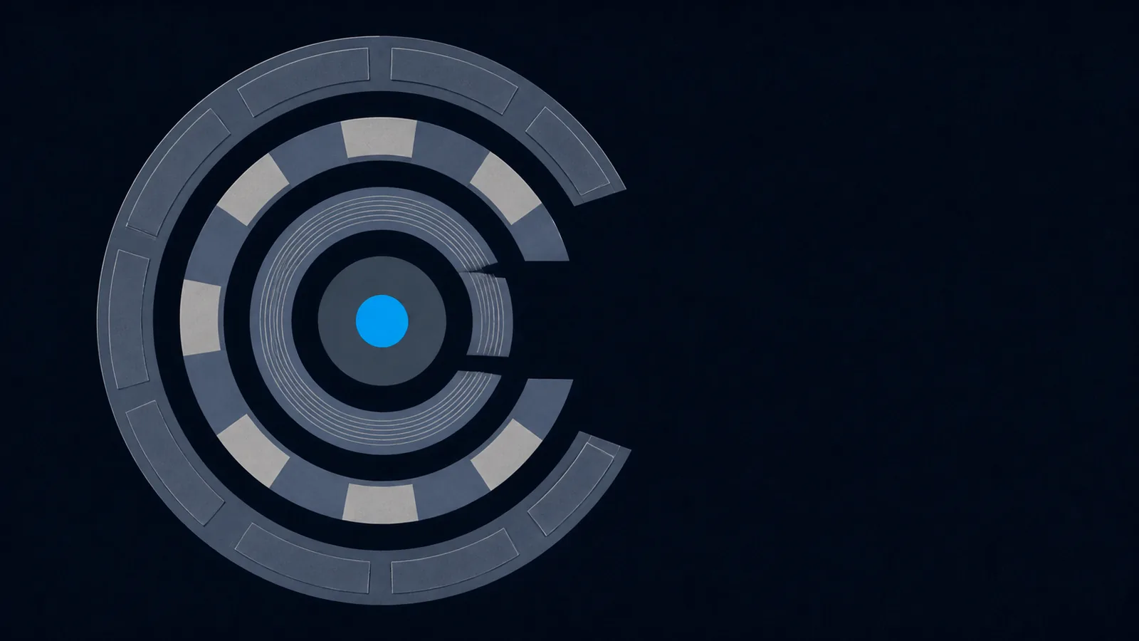 Four concentric rings opened along one side, revealing a small solid core at the centre.