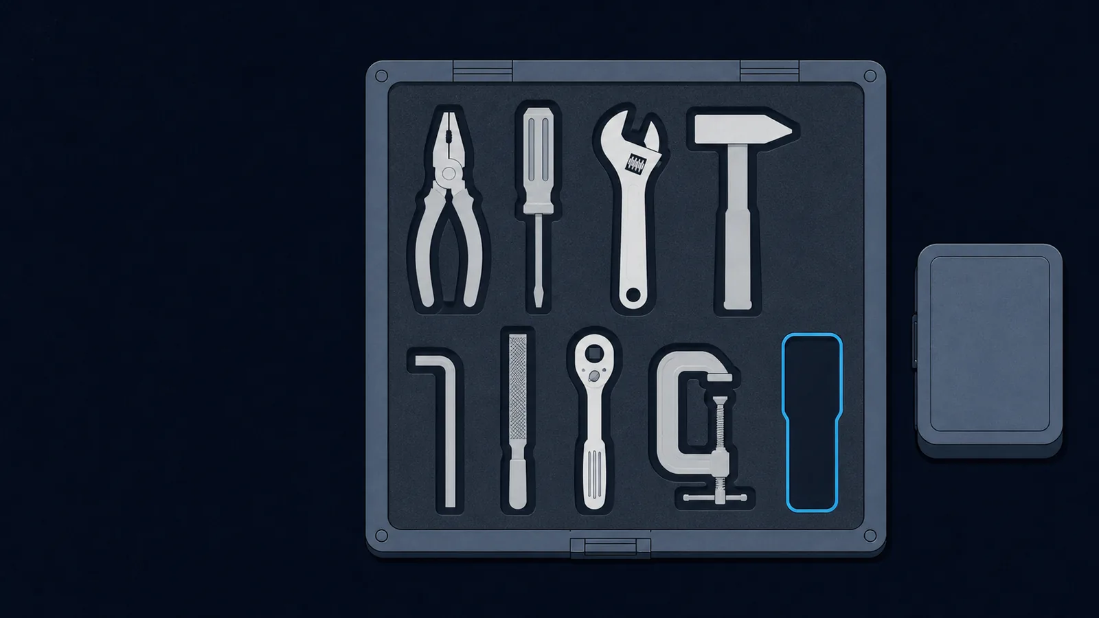 An overhead workbench tray of fitted tool recesses beside a small sealed container box.