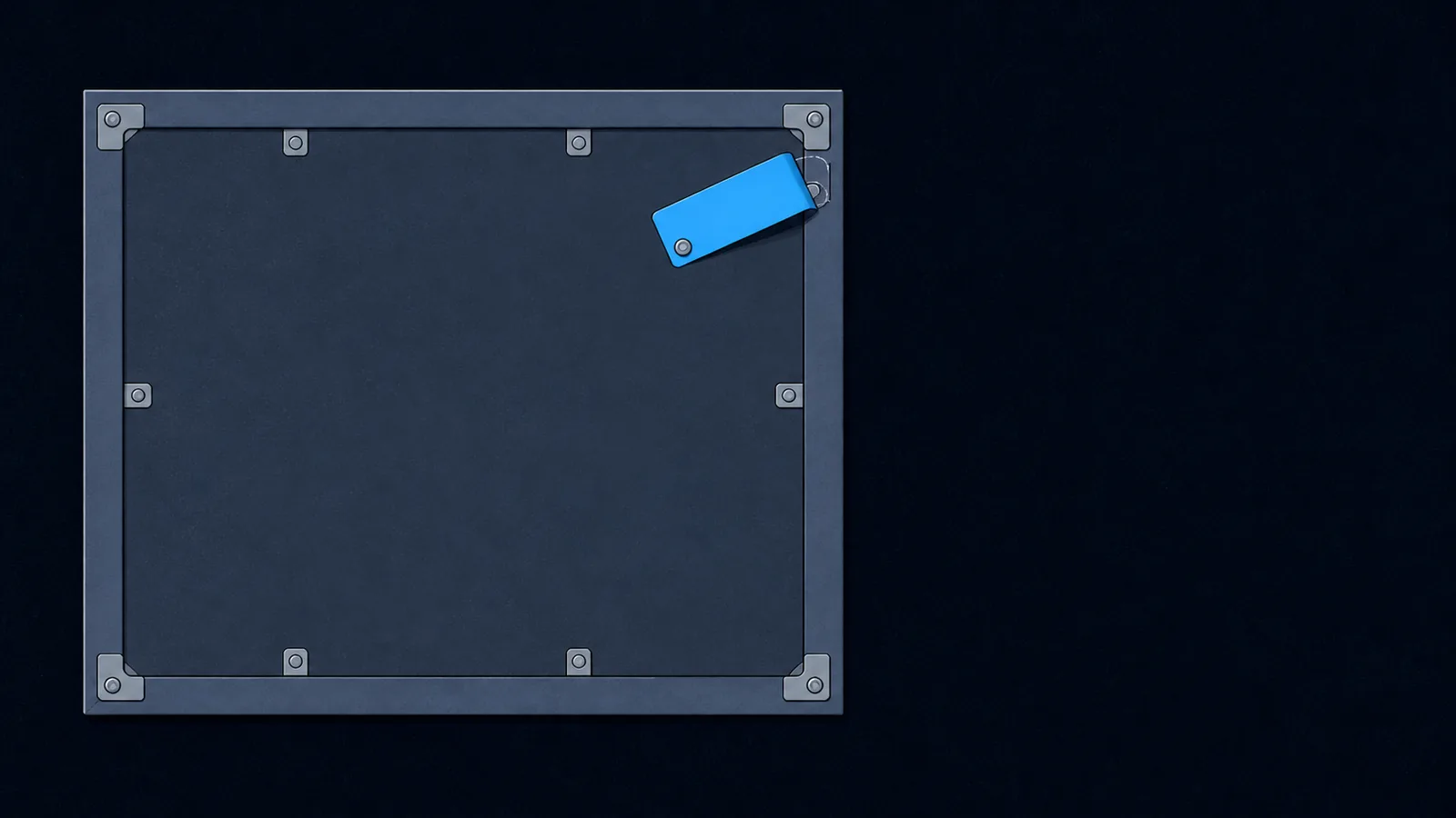A picture frame turned face-down, with a small blank tag plate lifted from its backing board.